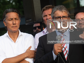 Sigmar Gabriel, the head of the supervisory board, speaks to the steelworkers after the press conference as a thousand steelworkers stand in...