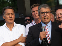 Sigmar Gabriel, the head of the supervisory board, speaks to the steelworkers after the press conference as a thousand steelworkers stand in...