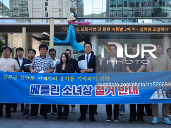 Democratic Party Youth Committee members, along with Rep. Jeon Yong-gi (center), gather in front of the Yonhap News Agency building in Seoul...