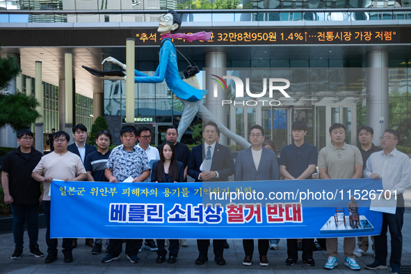 Democratic Party Youth Committee members, along with Rep. Jeon Yong-gi (center), gather in front of the Yonhap News Agency building in Seoul...