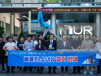 Democratic Party Youth Committee members, along with Rep. Jeon Yong-gi (center), gather in front of the Yonhap News Agency building in Seoul...