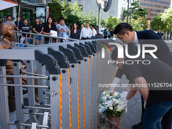 Members of the Democratic Party Youth Committee lay flowers in front of the Comfort Woman statue after holding the inauguration ceremony for...