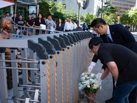 Members of the Democratic Party Youth Committee lay flowers in front of the Comfort Woman statue after holding the inauguration ceremony for...