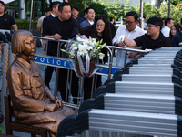 Members of the Democratic Party Youth Committee lay flowers in front of the Comfort Woman statue after holding the inauguration ceremony for...