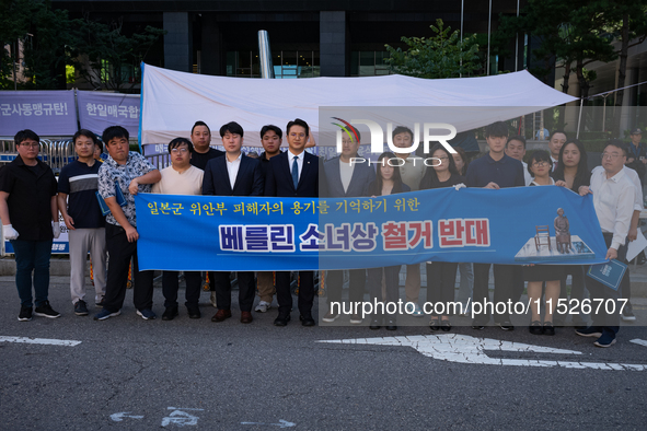 Democratic Party Youth Committee members, along with Rep. Jeon Yong-gi (center), gather in front of the Yonhap News Agency building in Seoul...