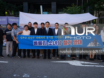 Democratic Party Youth Committee members, along with Rep. Jeon Yong-gi (center), gather in front of the Yonhap News Agency building in Seoul...