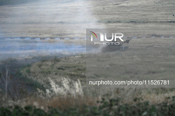 Tankers of the 118th Separate Mechanized Brigade drive a T-72 tank during the live-fire exercise in the Zaporizhzhia sector, Zaporizhzhia re...