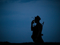 A serviceman of the 118th Separate Mechanized Brigade speaks into the radio during the night firing exercise in the Zaporizhzhia sector in t...