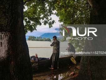 Kashmiris catch fish on the banks of Dal Lake in Srinagar, Jammu and Kashmir, on August 30, 2024. (