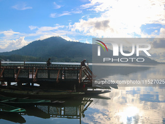 A Kashmiri man fishes on the banks of Dal Lake in Srinagar, Jammu and Kashmir, on August 30, 2024. (