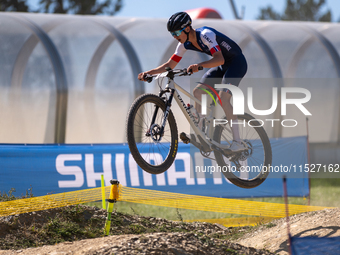 A cyclist participates in the UCI Mountain Bike World Championships Cross-Country Olympic Men Junior in Pal Arinsal, Andorra, on August 30,...