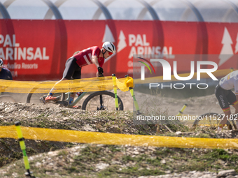 A cyclist participates in the UCI Mountain Bike World Championships Cross-Country Olympic Men Junior in Pal Arinsal, Andorra, on August 30,...