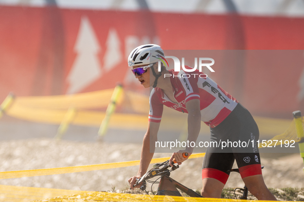 A cyclist participates in the UCI Mountain Bike World Championships Cross-Country Olympic Men Junior in Pal Arinsal, Andorra, on August 30,...