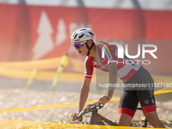 A cyclist participates in the UCI Mountain Bike World Championships Cross-Country Olympic Men Junior in Pal Arinsal, Andorra, on August 30,...