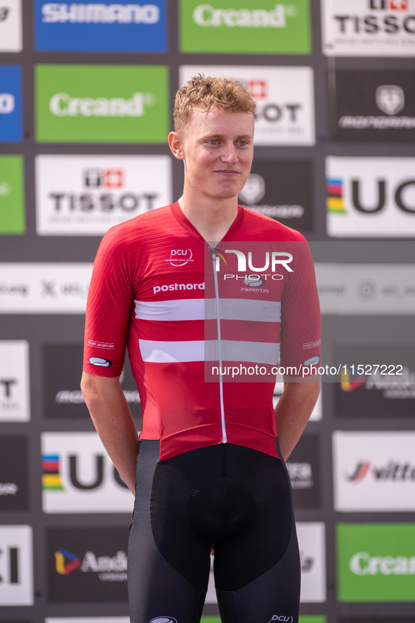 In Pal Arinsal, Andorra, on August 30, 2024, Nicolas Philipsen of Denmark celebrates on the podium for third place in the UCI Mountain Bike...