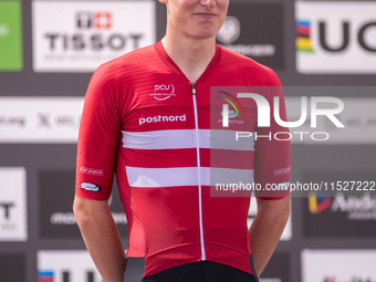 In Pal Arinsal, Andorra, on August 30, 2024, Nicolas Philipsen of Denmark celebrates on the podium for third place in the UCI Mountain Bike...