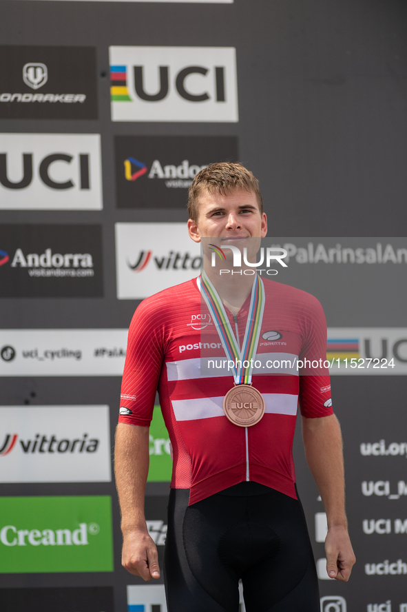 Henrique Hougs of Denmark celebrates on the podium for third place in the UCI Mountain Bike World Championships Cross-Country Olympic Men Ju...