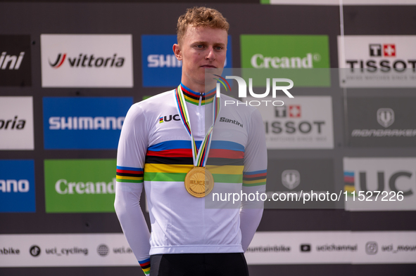 In Pal Arinsal, Andorra, on August 30, 2024, Nicolas Philipsen of Denmark celebrates on the podium for third place in the UCI Mountain Bike...