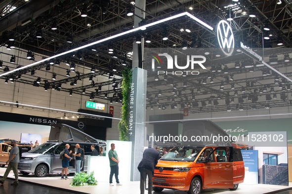 Visitors check Volkswagen camping vans at the Duesseldorf Trade Fair Center during the Caravan Salon, the leading motorhome and camping van...