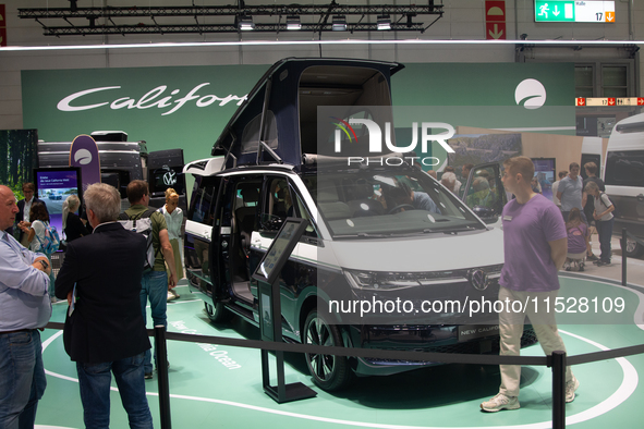 Visitors check Volkswagen camping vans at the Duesseldorf Trade Fair Center during the Caravan Salon, the leading motorhome and camping van...