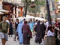 Families walk on a landmark Krupowki Street in the center of Zakopane, a popular Tatra mountain holiday resort on the last weekend of school...