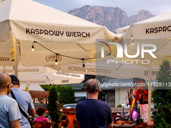 People rest in a bar on a landmark Krupowki Street in the center of Zakopane, a popular Tatra mountain holiday resort on the last weekend of...