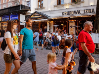 Families walk on a landmark Krupowki Street in the center of Zakopane, a popular Tatra mountain holiday resort on the last weekend of school...