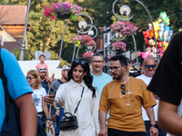 Families walk on a landmark Krupowki Street in the center of Zakopane, a popular Tatra mountain holiday resort on the last weekend of school...