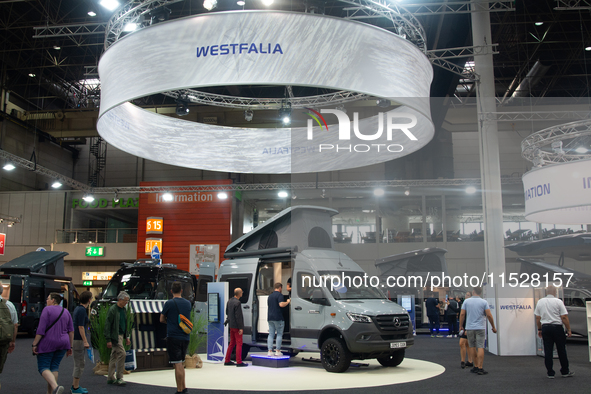 Visitors check Westfalia camping vans at the Duesseldorf Trade Fair Center during the Caravan Salon, the leading motorhome and camping van t...