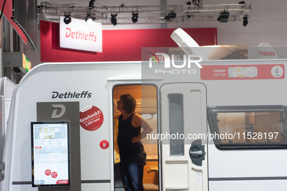 A visitor checks the Dethleffs camping van at the Duesseldorf Trade Fair Center during the Caravan Salon, the leading motorhome and camping...