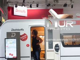 A visitor checks the Dethleffs camping van at the Duesseldorf Trade Fair Center during the Caravan Salon, the leading motorhome and camping...