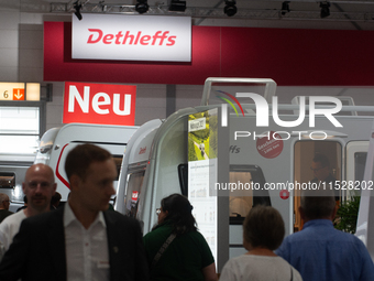 Visitors check Dethleffs camping vans at the Duesseldorf Trade Fair Center during the Caravan Salon, the leading motorhome and camping van t...