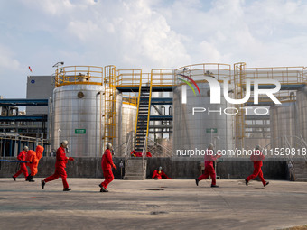 Workers are evacuated at the site of an emergency drill for hazardous chemical production safety accidents at a chemical park in Hefei, Chin...