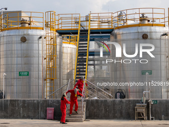 Workers are evacuated at the site of an emergency drill for hazardous chemical production safety accidents at a chemical park in Hefei, Chin...