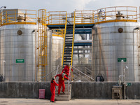 Workers are evacuated at the site of an emergency drill for hazardous chemical production safety accidents at a chemical park in Hefei, Chin...