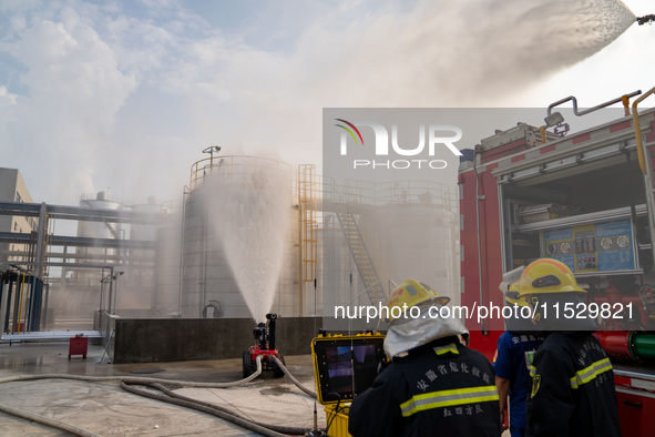 Firefighters fight a fire at the site of an emergency drill for hazardous chemicals production in a chemical park in Hefei, China, on August...