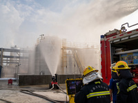 Firefighters fight a fire at the site of an emergency drill for hazardous chemicals production in a chemical park in Hefei, China, on August...