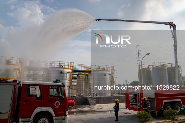 Firefighters fight a fire at the site of an emergency drill for hazardous chemicals production in a chemical park in Hefei, China, on August...