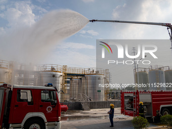 Firefighters fight a fire at the site of an emergency drill for hazardous chemicals production in a chemical park in Hefei, China, on August...