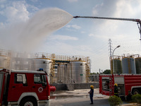 Firefighters fight a fire at the site of an emergency drill for hazardous chemicals production in a chemical park in Hefei, China, on August...