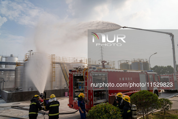 Firefighters fight a fire at the site of an emergency drill for hazardous chemicals production in a chemical park in Hefei, China, on August...