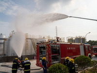 Firefighters fight a fire at the site of an emergency drill for hazardous chemicals production in a chemical park in Hefei, China, on August...