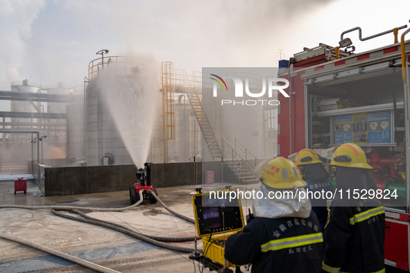 Firefighters fight a fire at the site of an emergency drill for hazardous chemicals production in a chemical park in Hefei, China, on August...