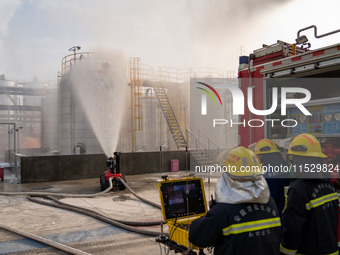 Firefighters fight a fire at the site of an emergency drill for hazardous chemicals production in a chemical park in Hefei, China, on August...