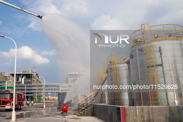 Firefighters fight a fire at the site of an emergency drill for hazardous chemicals production in a chemical park in Hefei, China, on August...