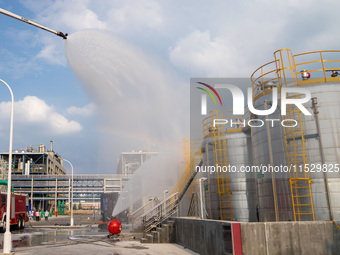 Firefighters fight a fire at the site of an emergency drill for hazardous chemicals production in a chemical park in Hefei, China, on August...