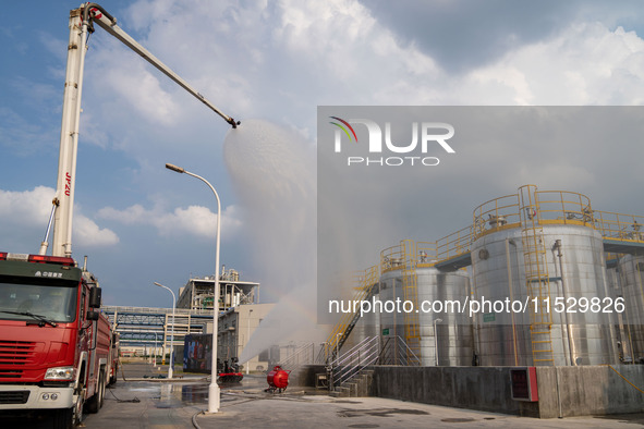 Firefighters fight a fire at the site of an emergency drill for hazardous chemicals production in a chemical park in Hefei, China, on August...