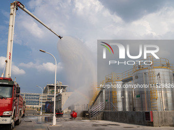 Firefighters fight a fire at the site of an emergency drill for hazardous chemicals production in a chemical park in Hefei, China, on August...