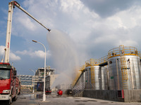 Firefighters fight a fire at the site of an emergency drill for hazardous chemicals production in a chemical park in Hefei, China, on August...