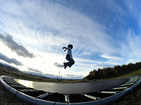 A little girl, Minudi Menulya, jumps on a trampoline in Twizel, New Zealand, on August 30, 2024. (